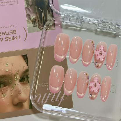 Set of pink nail designs in a clear case with a magazine in the background