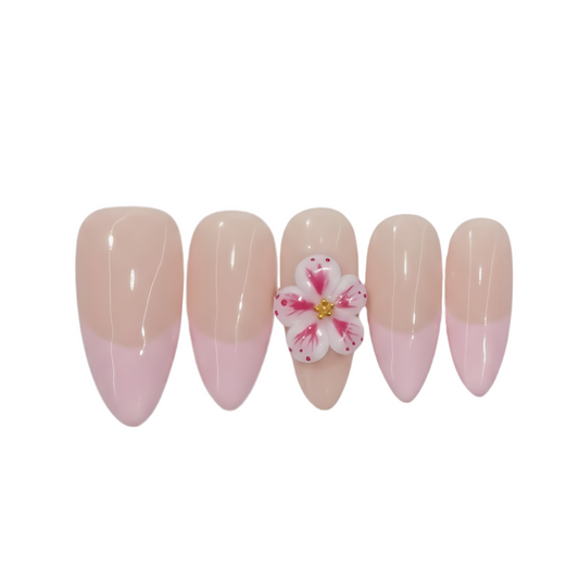 Set of five beige and pink gradient nails with a central flower design on a white background