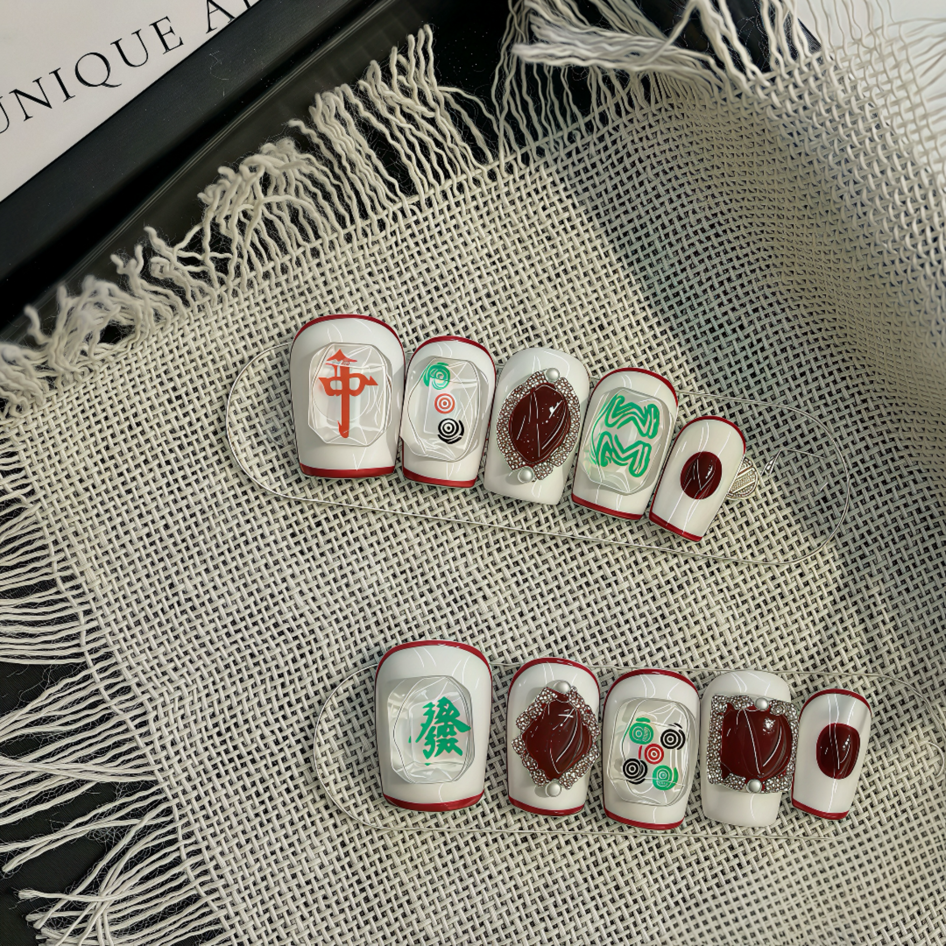 Set of small decorative items with unique designs on a textured fabric background