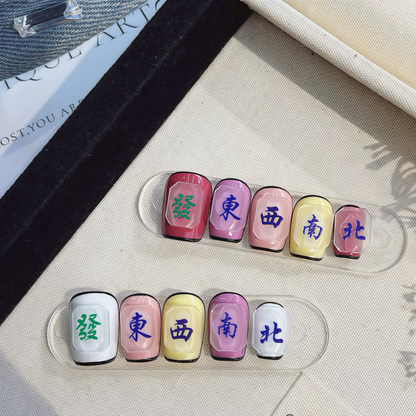 Set of colorful nail art with Chinese characters on a clear stand.