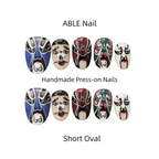 Handmade press-on nails with artistic designs on a white background, labeled 'ABLE Nail'.