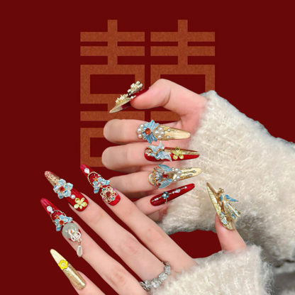 Decorative nail art with colorful designs on a red background with Chinese characters.