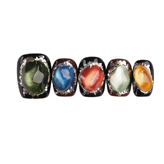 Five nail art designs with different colored stones on a white background