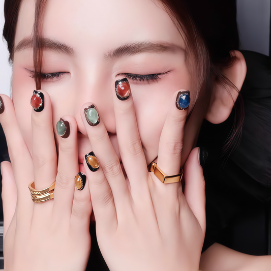 Woman with colorful nail polish and rings covering her face