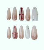 Set of false nails with a gradient design and embedded rhinestones on a white background