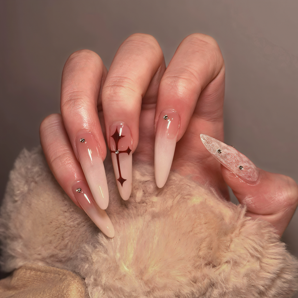 Close-up of a hand with long, decorative nails holding a fluffy beige object.
