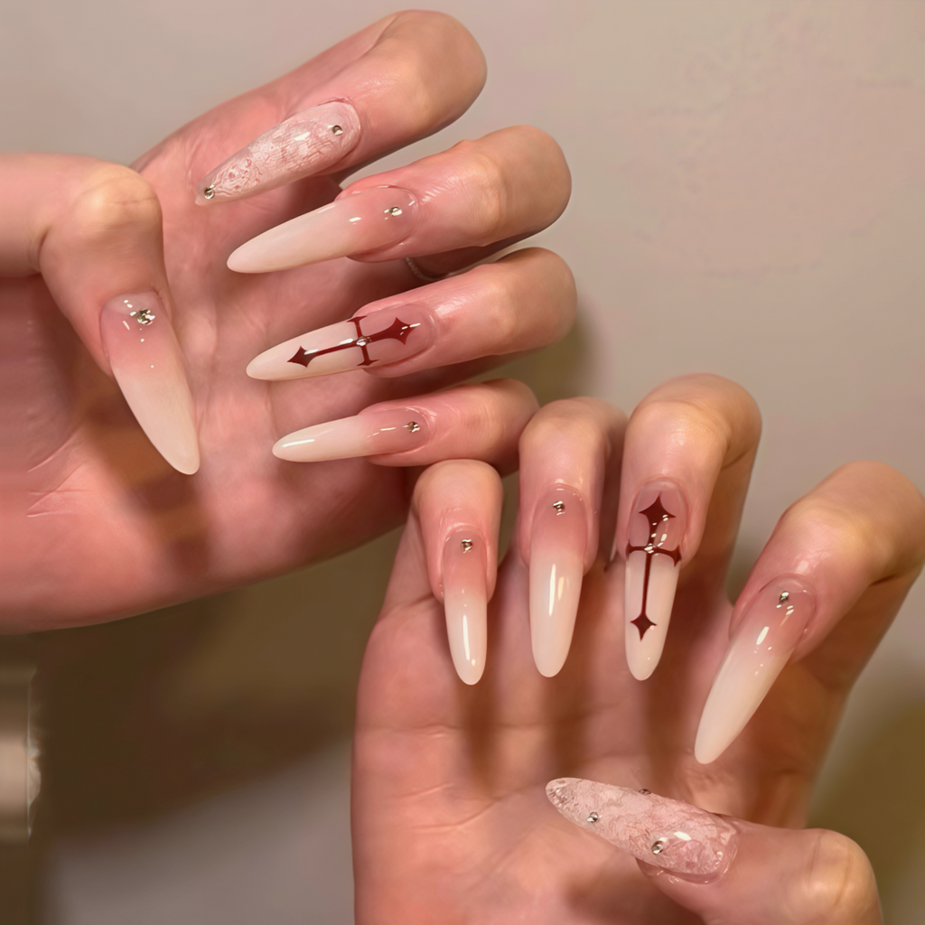 Close-up of hands with decorative nail art on a neutral background