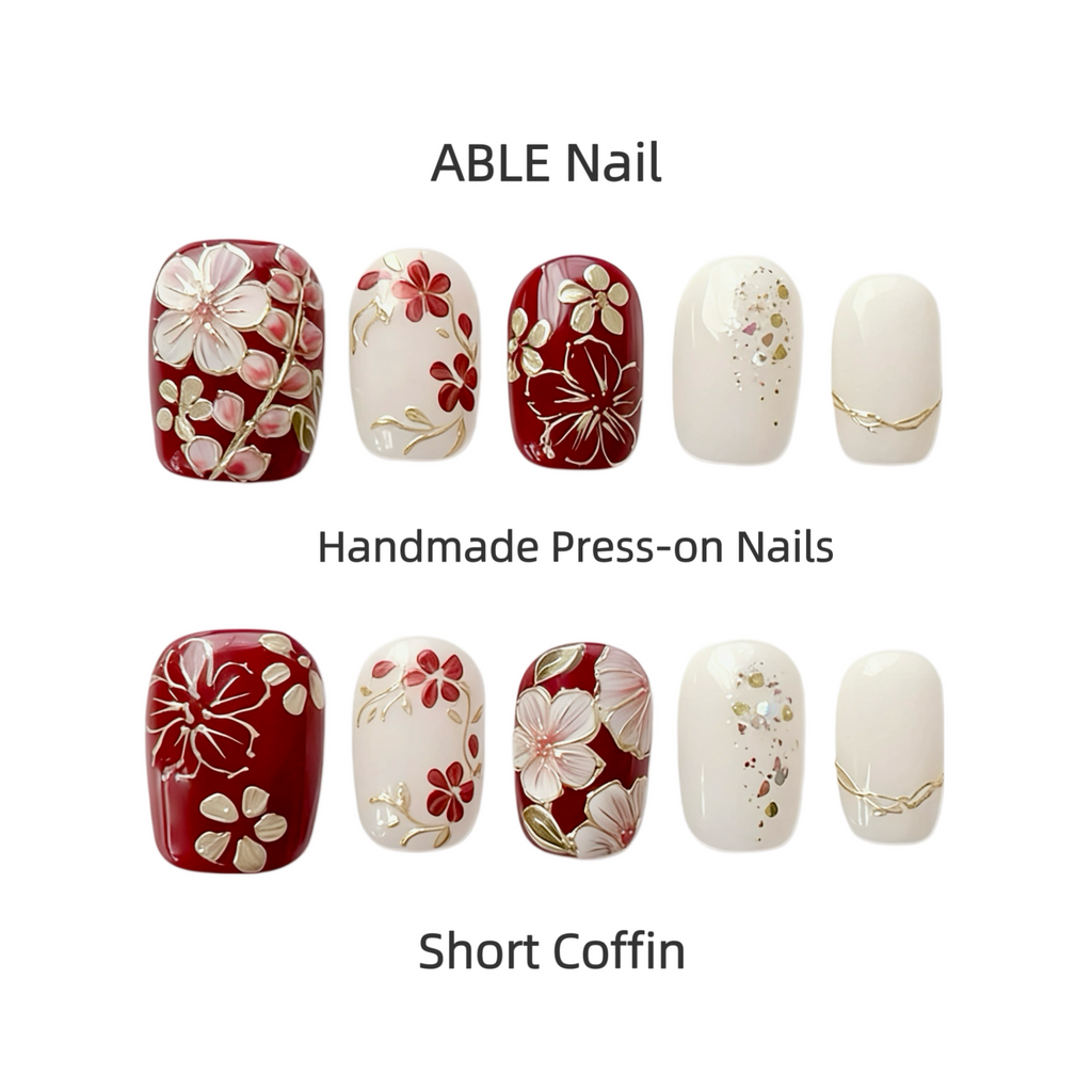 Handmade press-on nails with floral designs by ABLE Nail on a white background.
