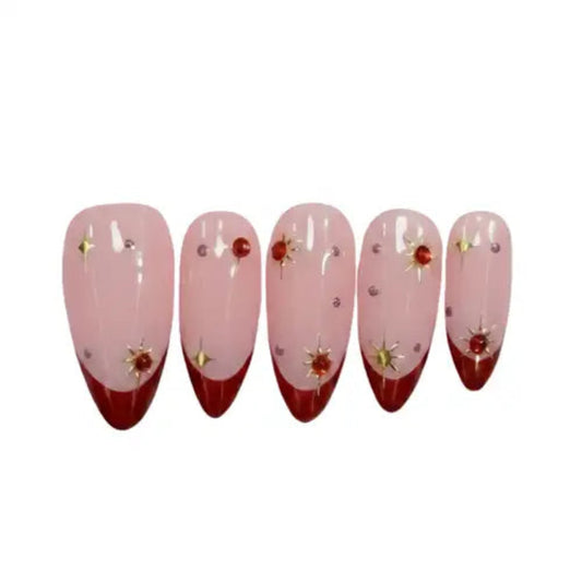 Set of five pink and red nail extensions with decorative elements on a white background