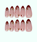 Set of pink nail art designs with red tips and decorative elements on a white background