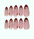 Set of pink nail art designs with red tips and decorative elements on a white background