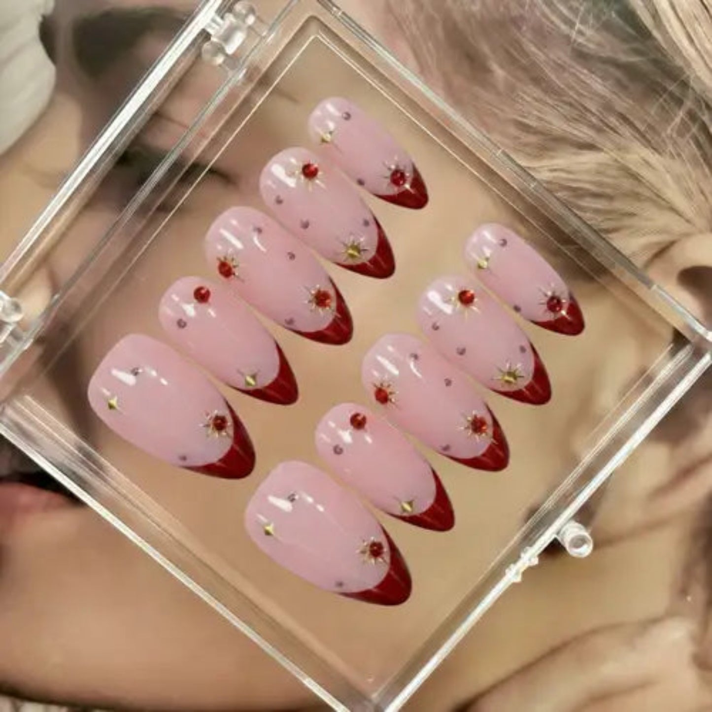 Set of pink and red nail art designs in a clear case.