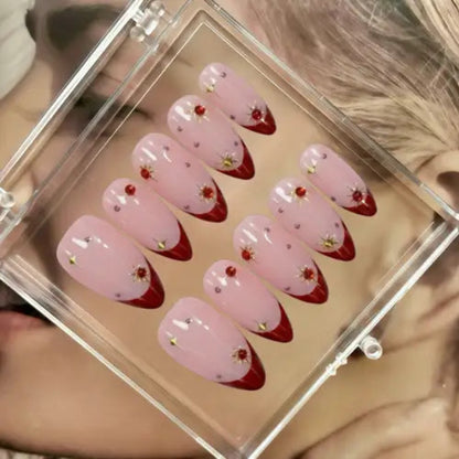 Set of pink and red nail art designs in a clear case.