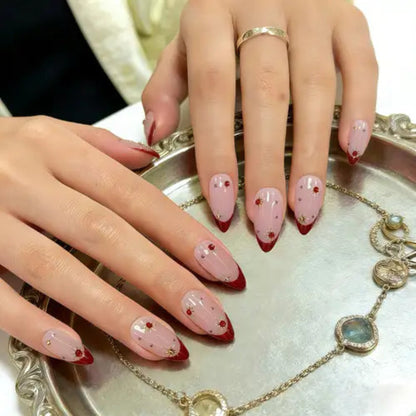 Close-up of hands with decorative nail art on a silver tray