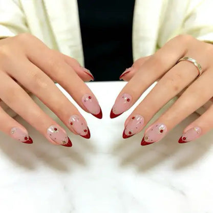 Close-up of hands with pink and red nail polish on a white background