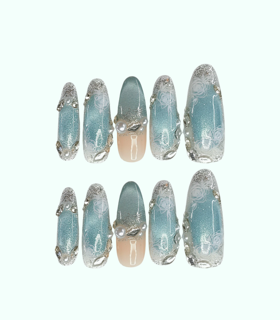 Set of decorative nails with a light blue and silver design on a white background