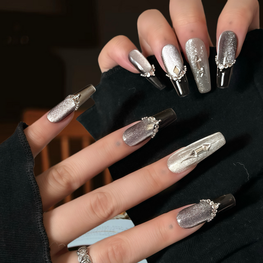 Hand with decorative nails on a dark background