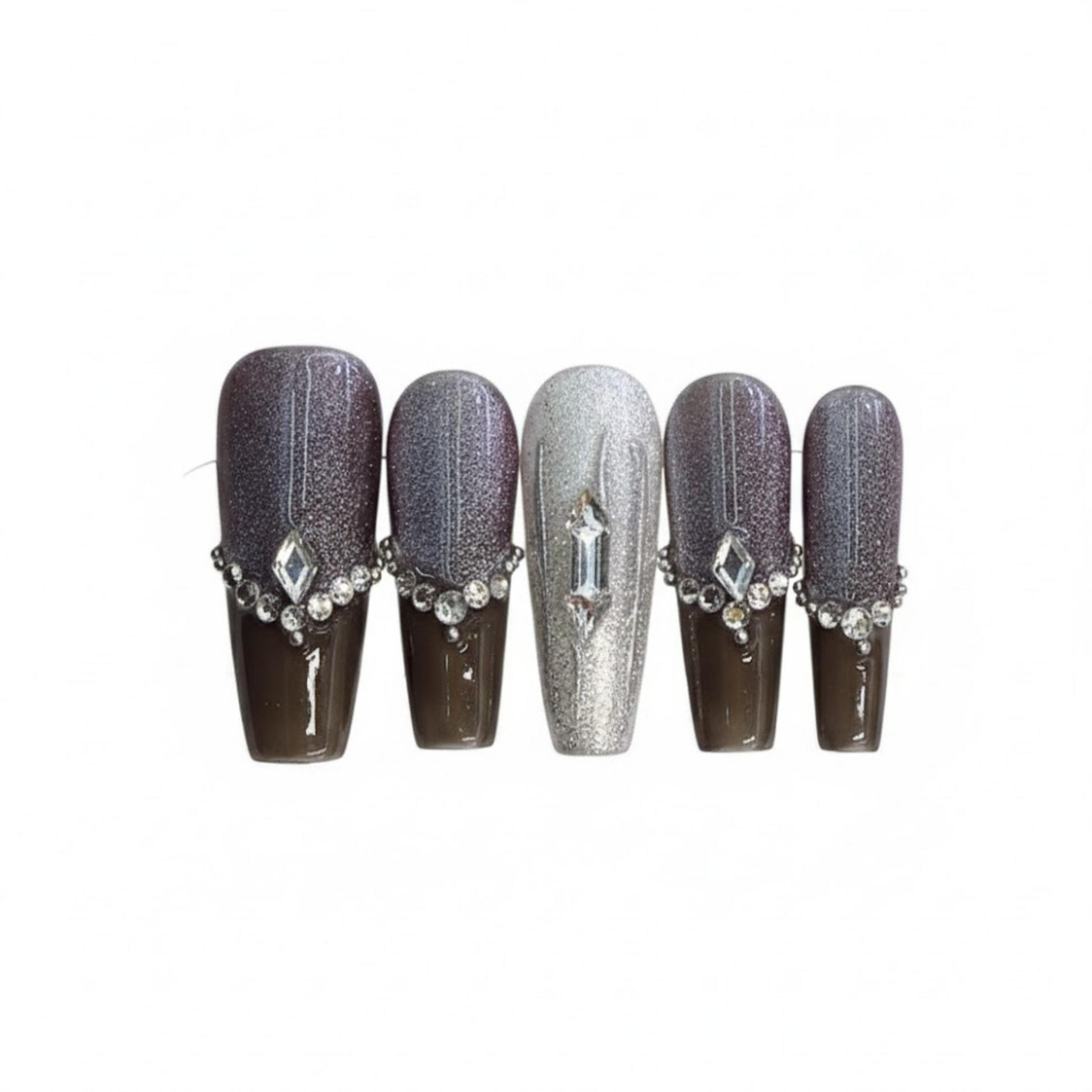 Set of five decorative nails with gemstone accents on a white background