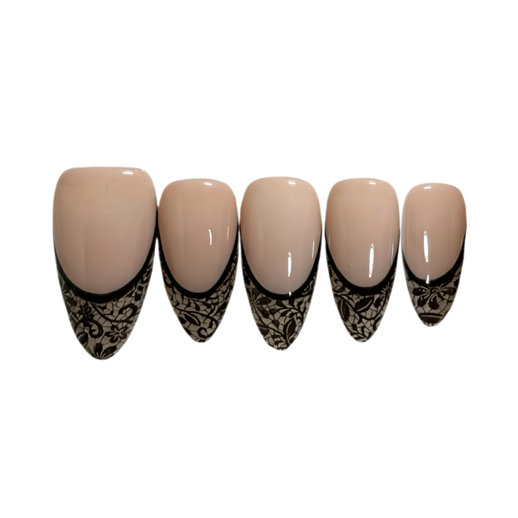 Set of beige nail tips with black lace design on a white background