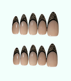 Set of beige nail tips with black lace designs on a white background