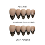 Handmade press-on nails with black lace design on a white background, labeled 'ABLE Nail'.