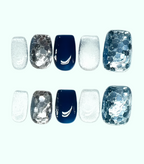 Set of nail wraps with blue and silver designs on a white background