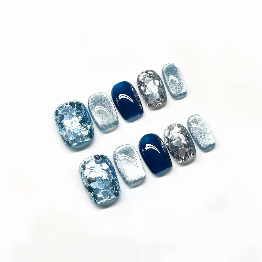 Nail art display with blue and silver designs on a white background