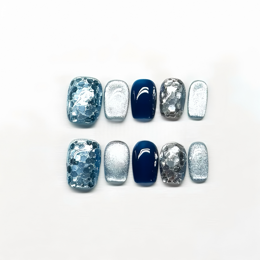 Nail art display with blue and silver designs on a white background