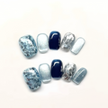 Set of blue and silver nail designs on a white background