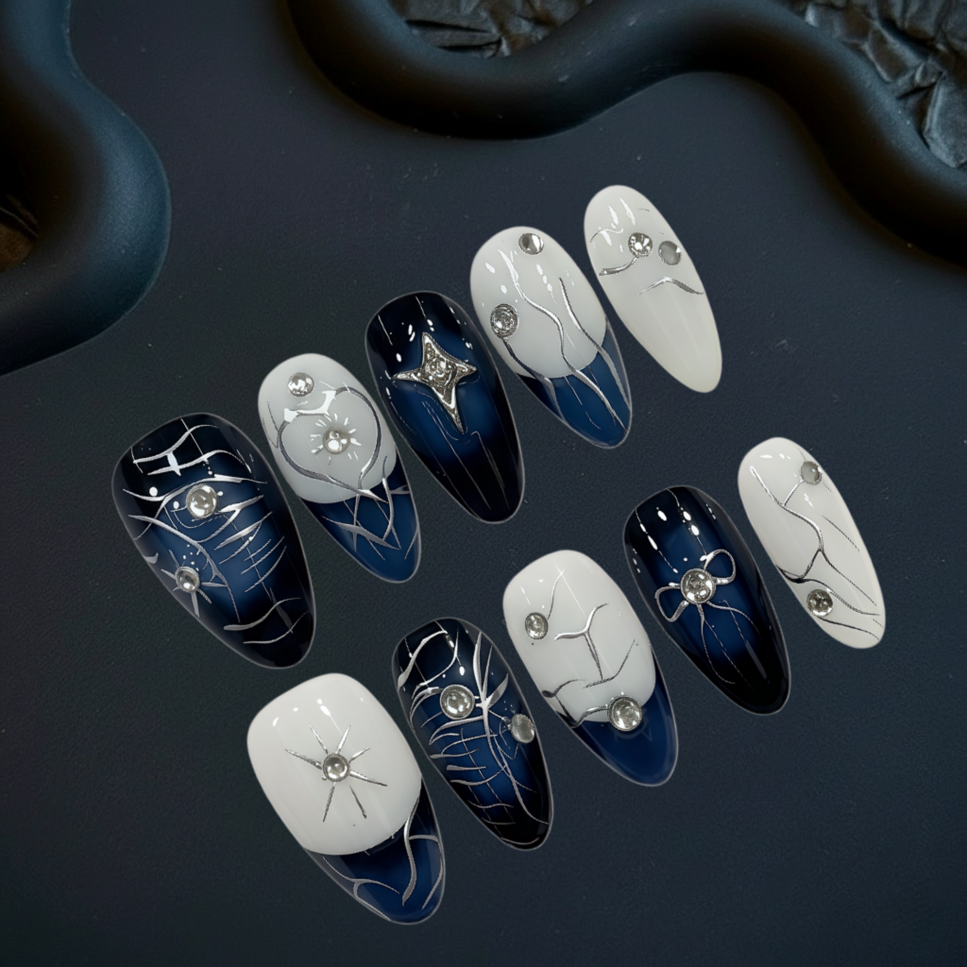 Set of nail art designs on a dark surface