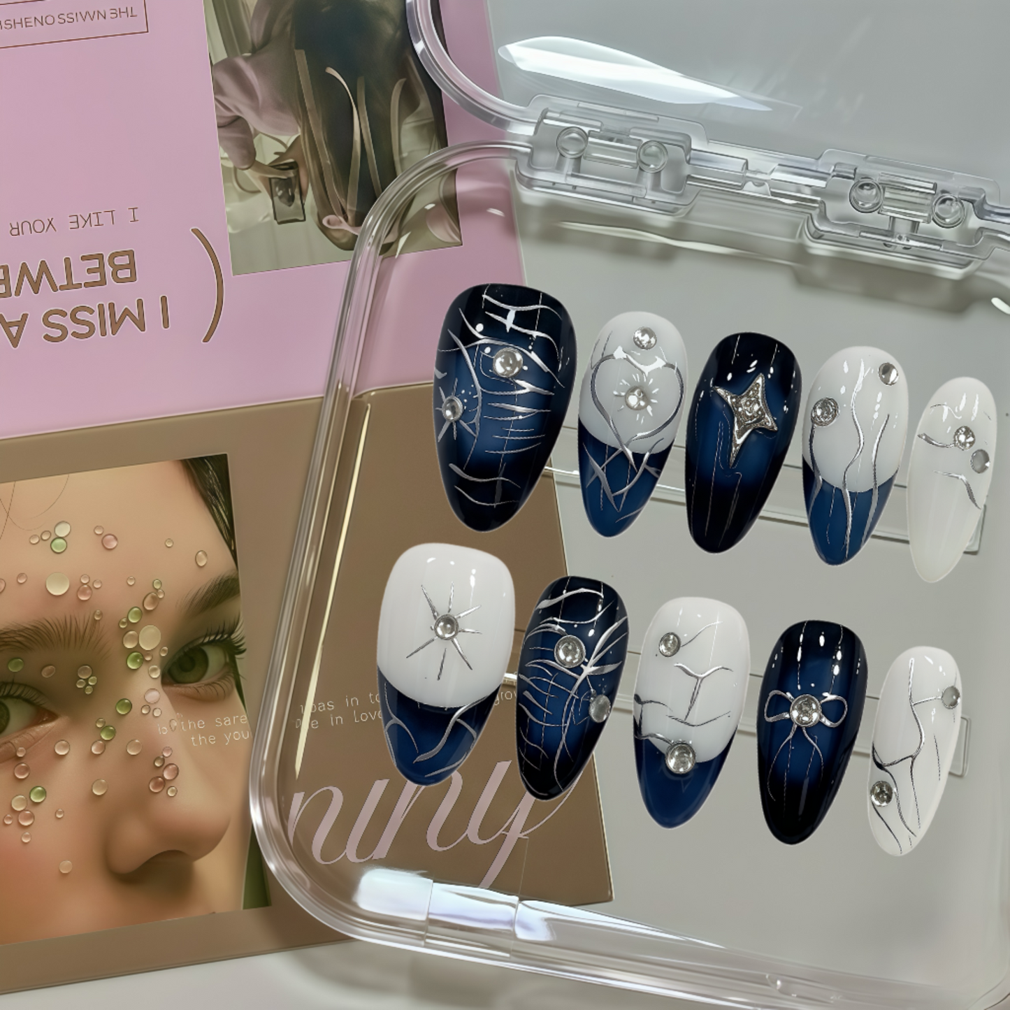 Set of blue and white decorative nails in a clear case with a woman's face in the corner.