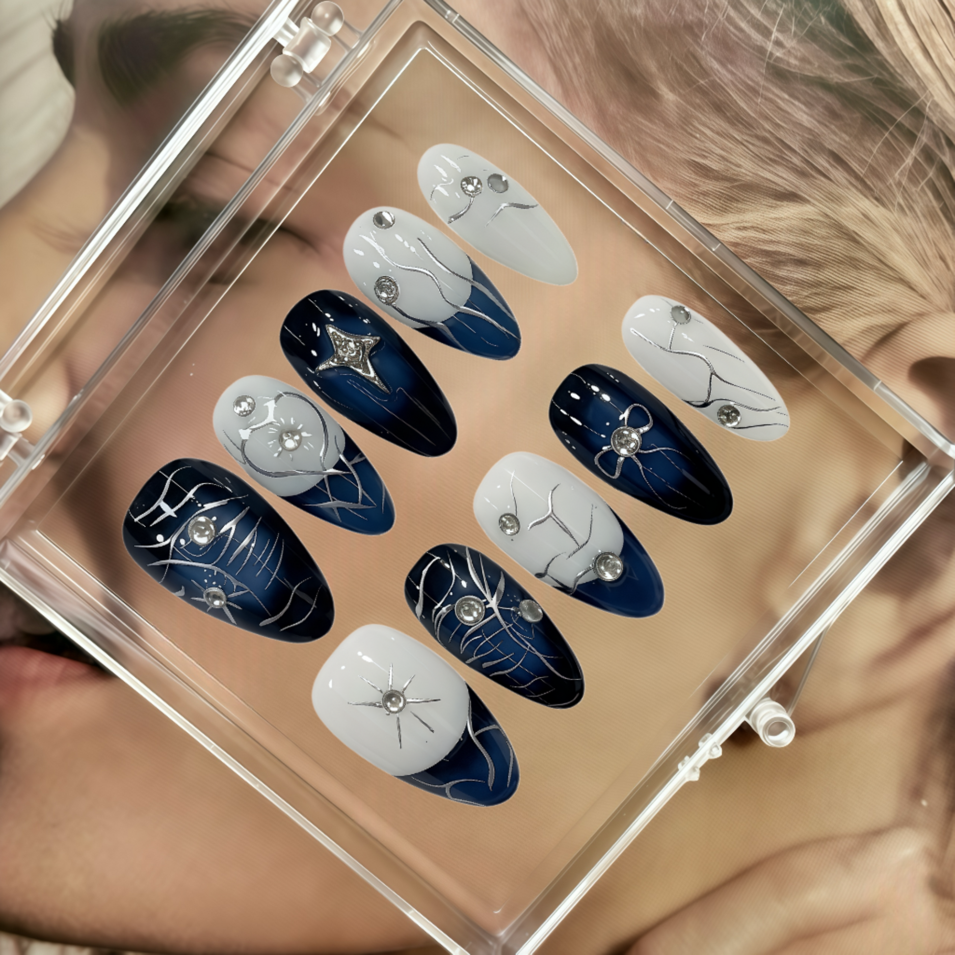 Set of blue and white nail art designs in a clear case.