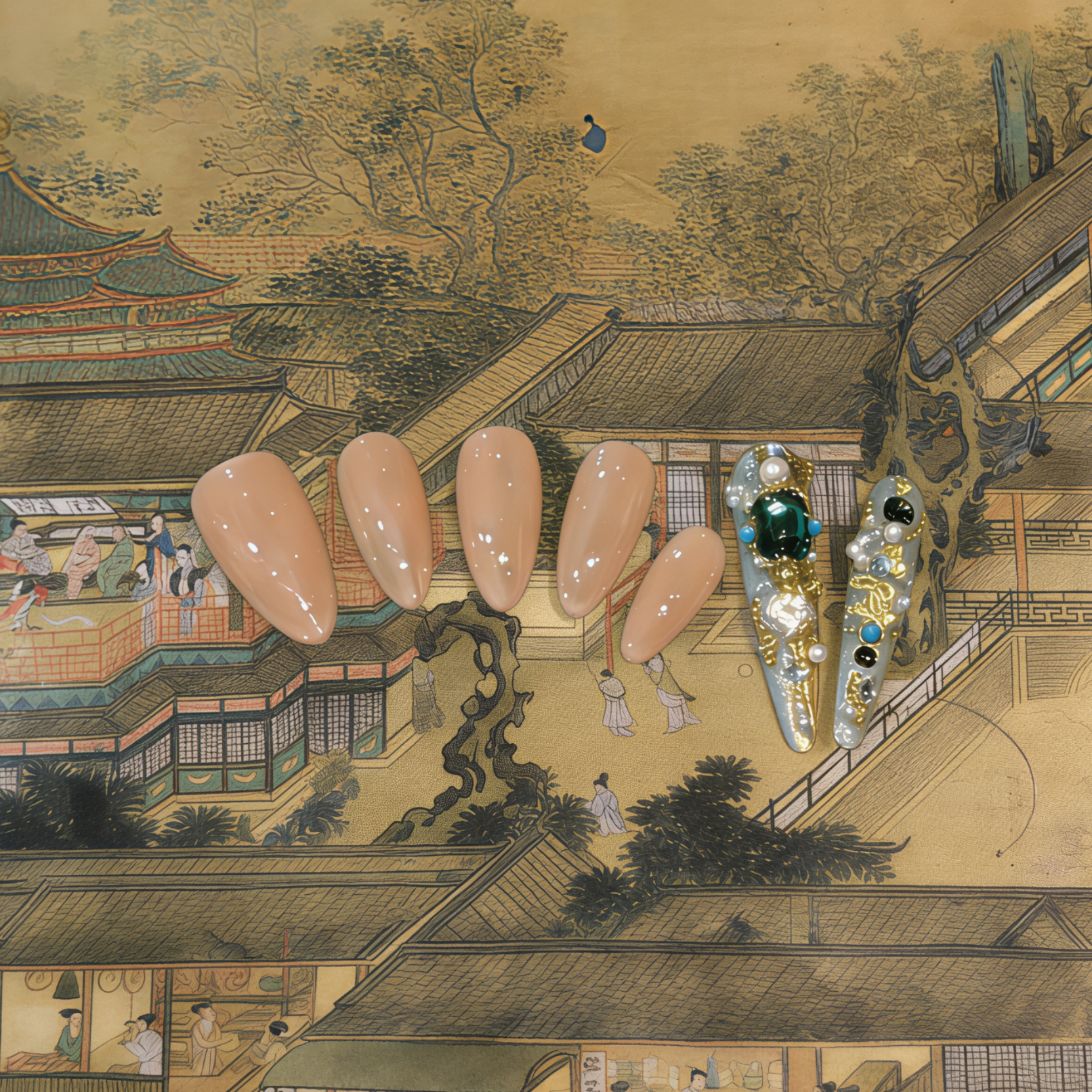 Manicured nails with decorative elements against a traditional Japanese scene background