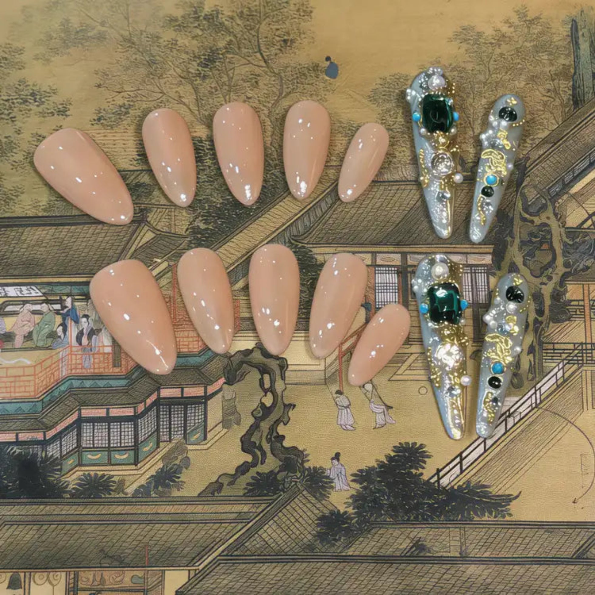 Set of false nails and decorative nail art designs on a traditional Japanese painting background
