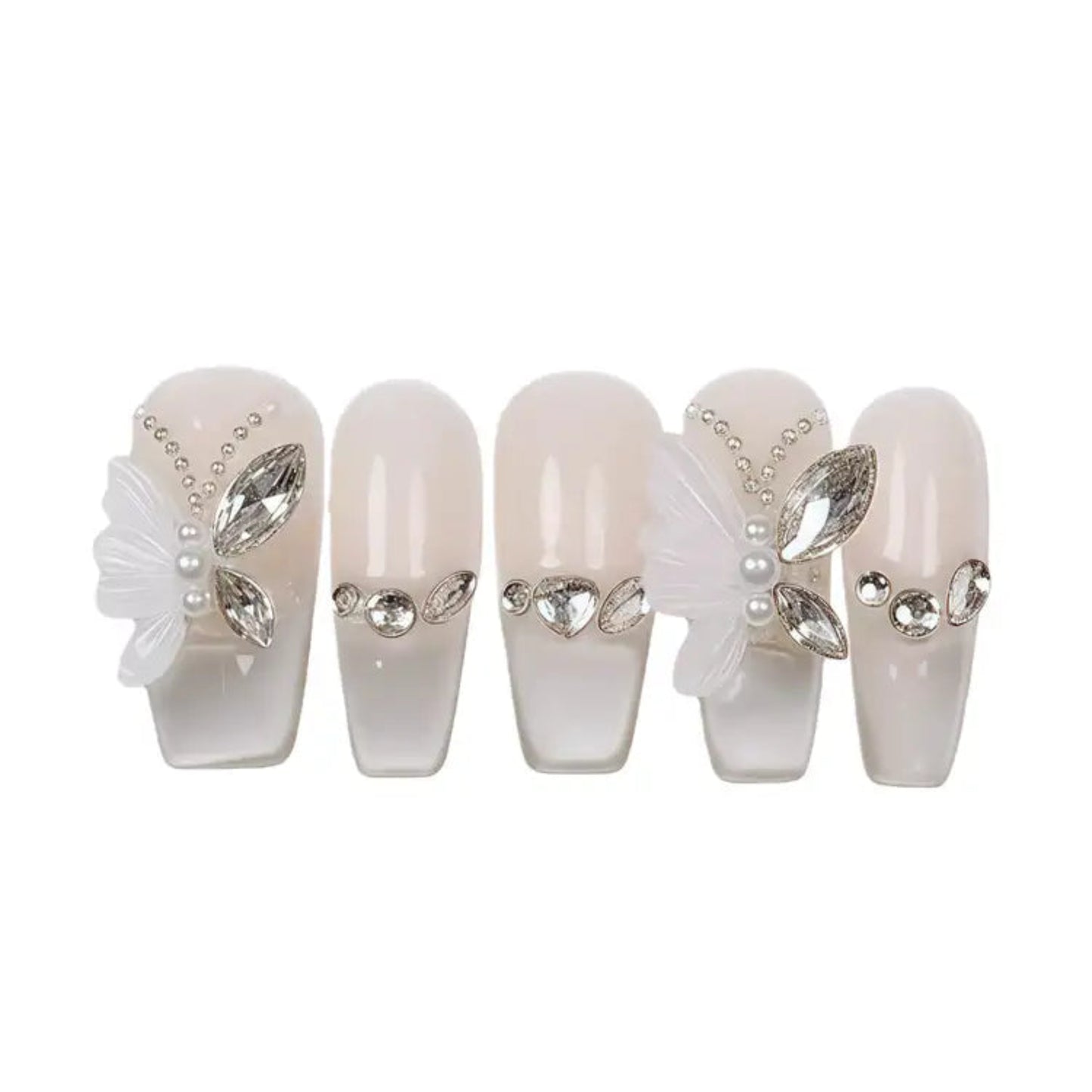 Set of decorative false nails with pearls and rhinestones on a white background