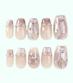 Set of decorative nail art with pearls and gold accents on a white background