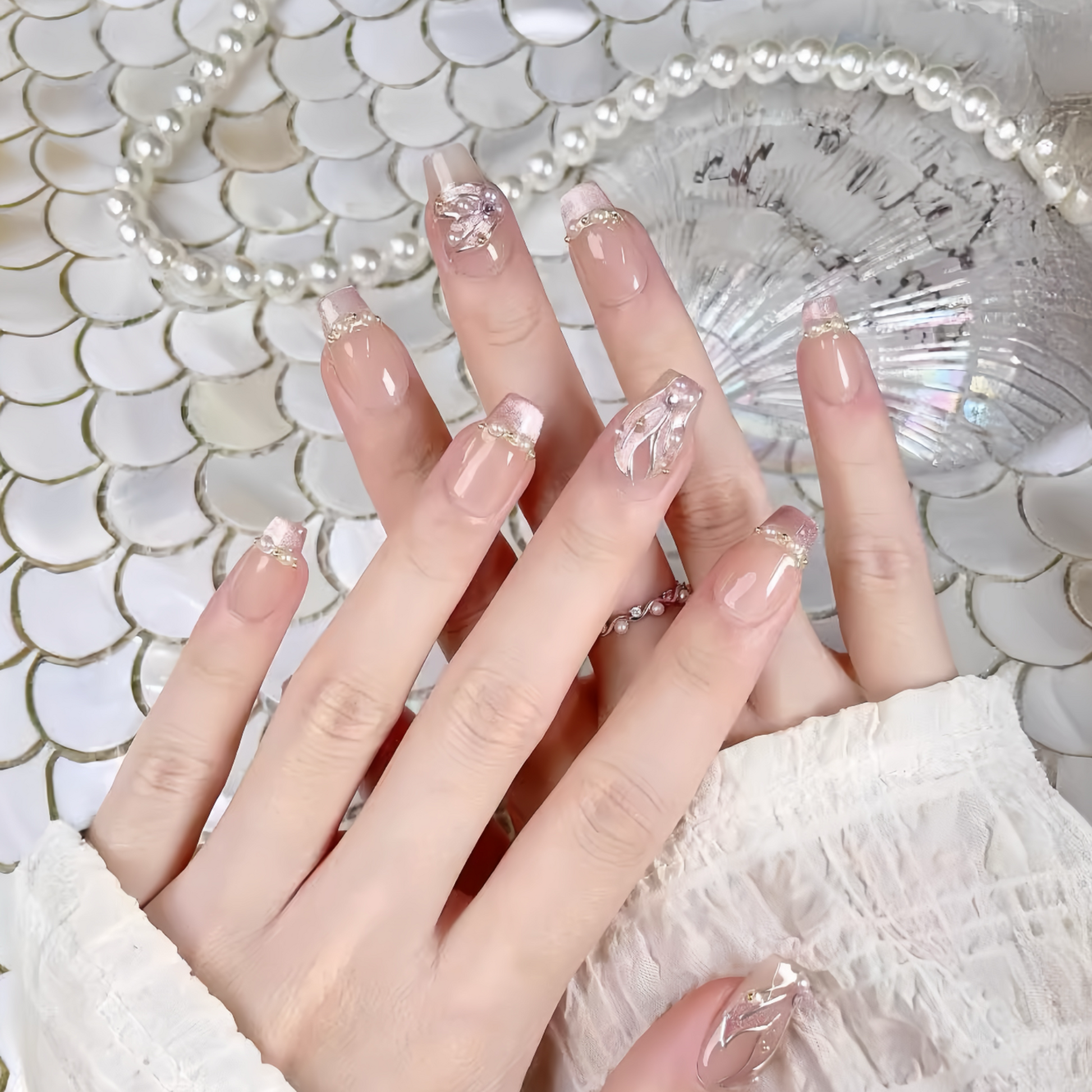 Close-up of hands with decorative nails against a textured background