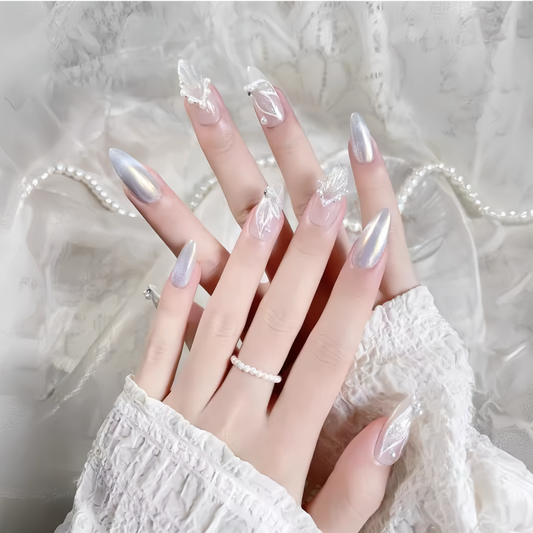 Hand with long, decorative nails against a soft, neutral background