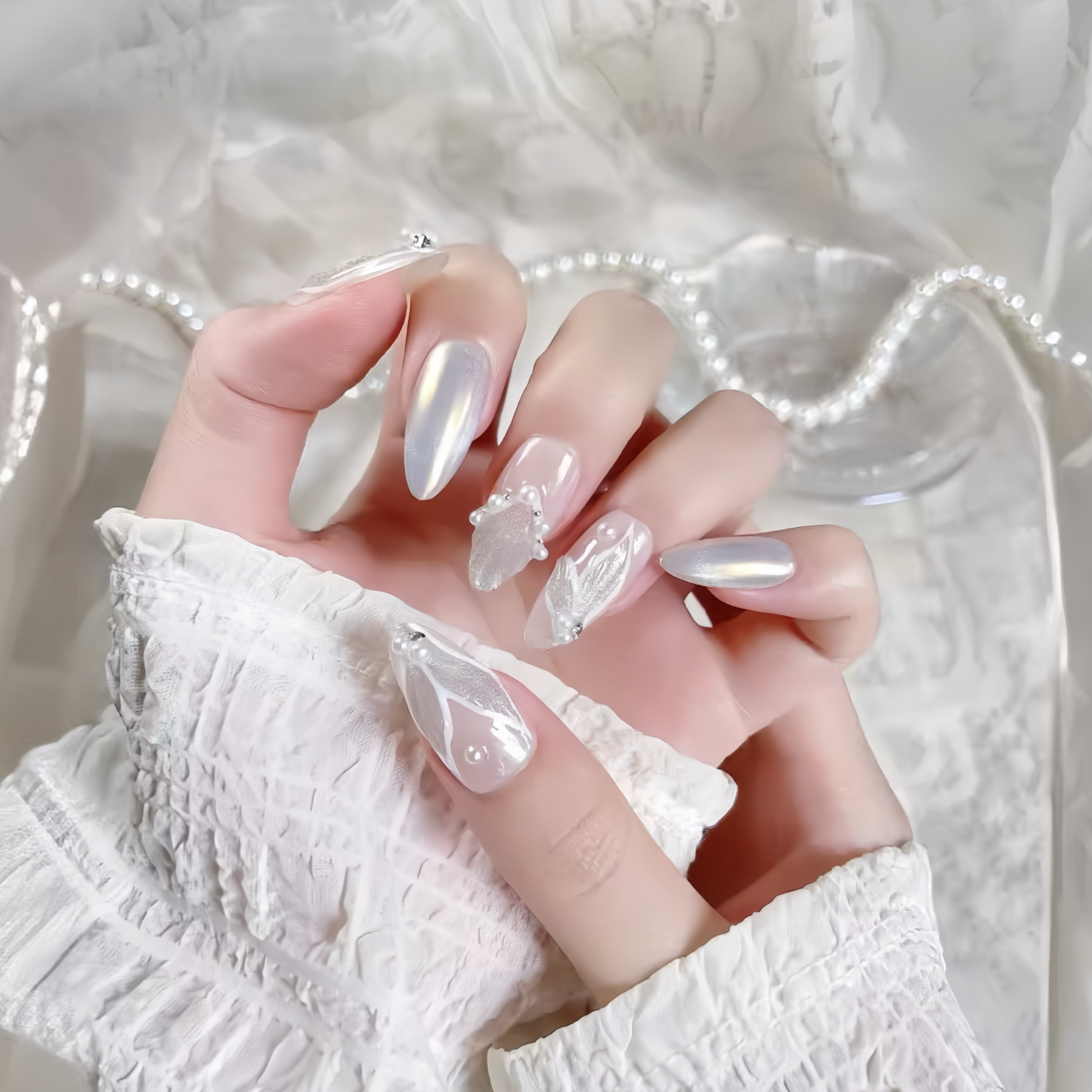 Hand with clear nail polish on a textured white background
