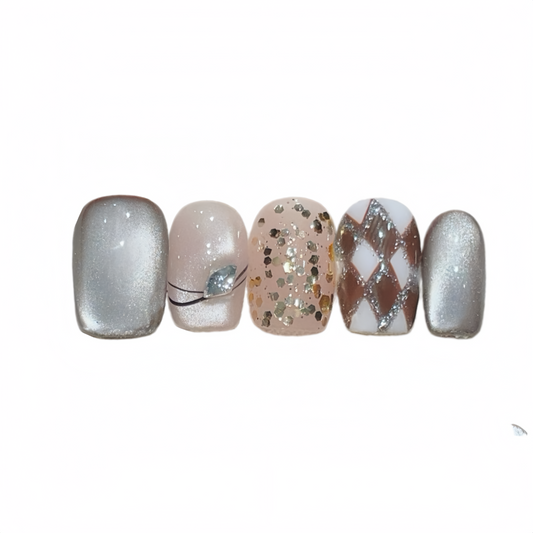 Five nail samples with various designs on a white background