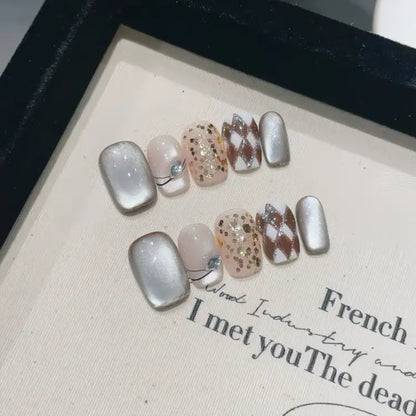 Set of decorative false nails on a textured surface with text.