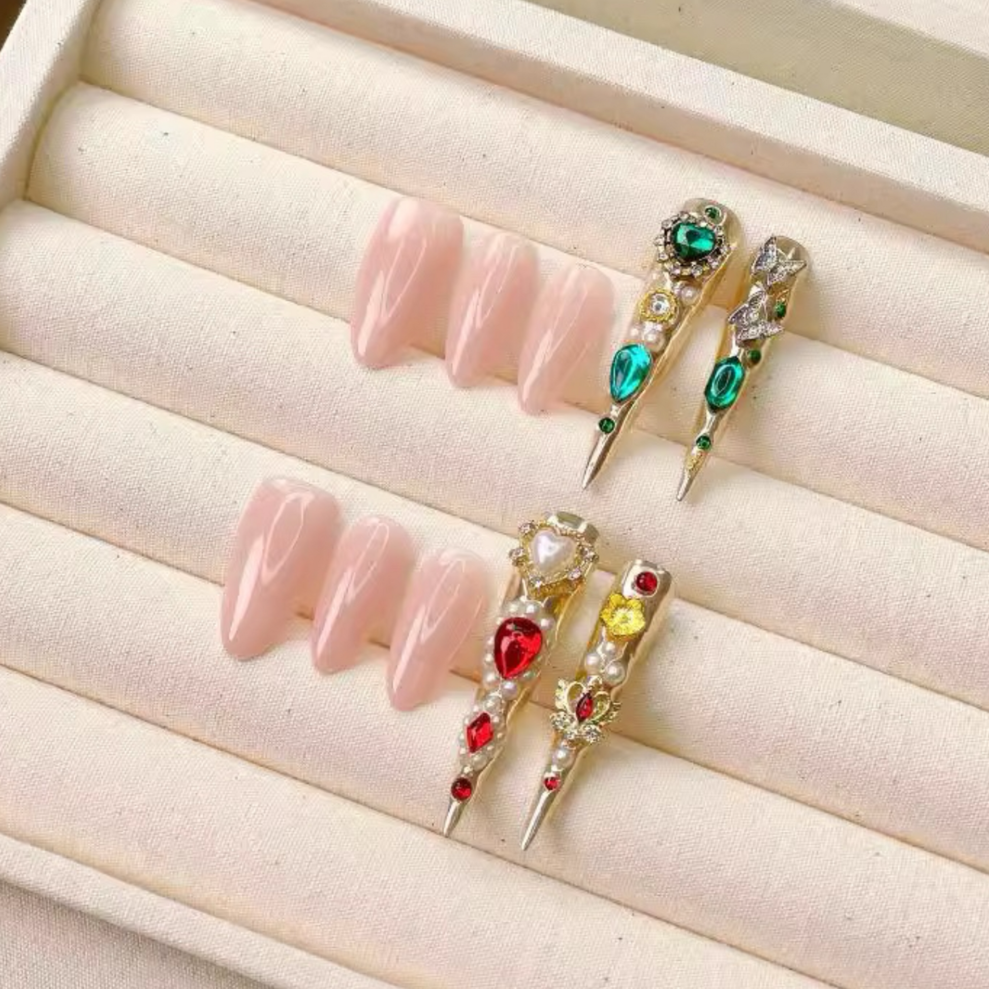 Decorative false nails with gemstones on a beige surface