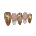 Set of nail art designs with gold, white, and pink colors on a white background