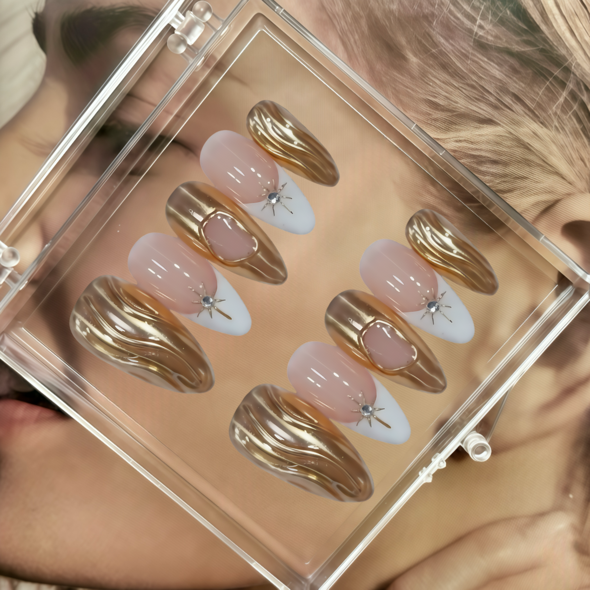 Set of gold and pink nail art designs in a clear case.