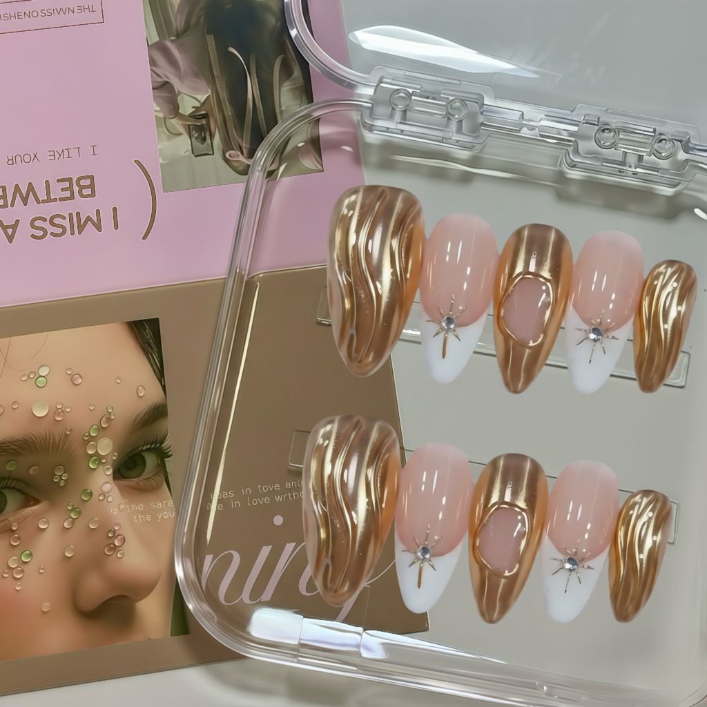 Set of gold and pink nail art designs in a clear case with a magazine in the background.