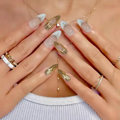 Close-up of hands with decorative nails and gold jewelry