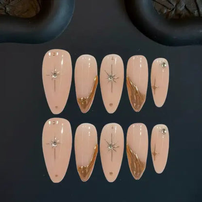 Set of decorative false nails with gold and silver designs on a dark background