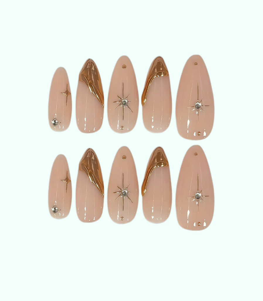 Set of beige nail extensions with gold and silver decorations on a white background