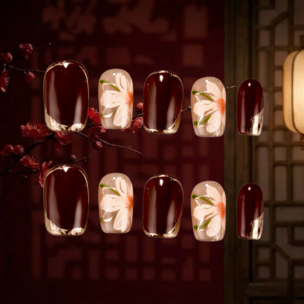 Nail art with floral designs on a dark background