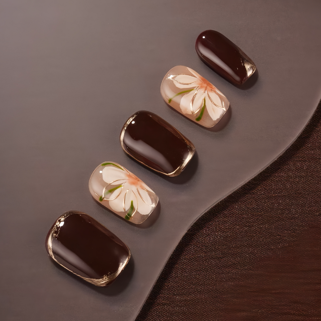 Chocolate candies with floral designs on a dark surface